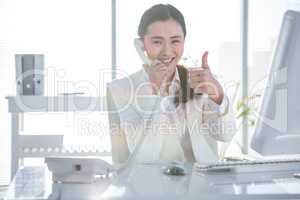 Smiling businesswoman using her telephone