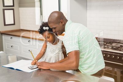 Father helping his daughter with homework