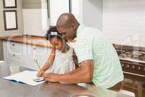 Father helping his daughter with homework