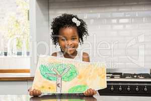 Smiling girl showing his drawing