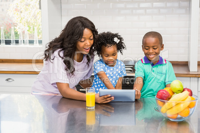 Mother and children using tablet