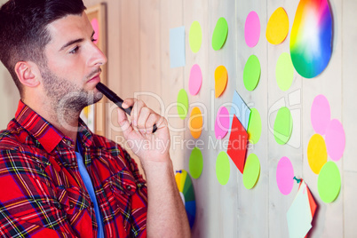 Creative worker using wall for brainstorm