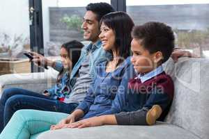 Happy young family watching tv