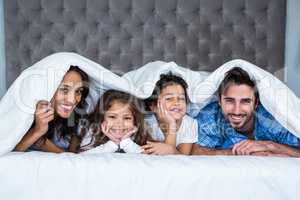 Happy family under the blanket