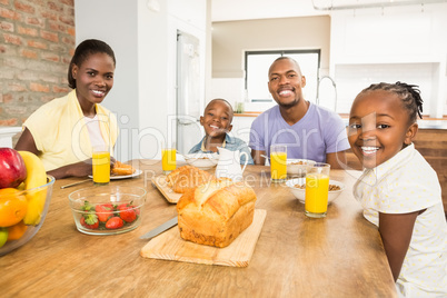 Casual happy family having breakfast