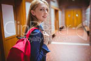 Pretty student with backpack looking at the camera