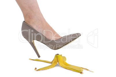 Cropped image of businesswoman crushing banana skin