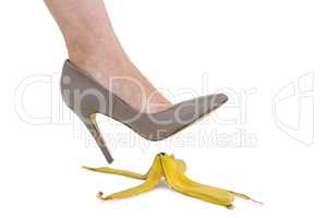 Cropped image of businesswoman crushing banana skin