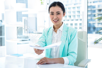 Smiling businesswoman taking notes