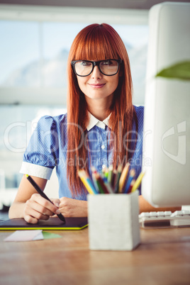 Attractive hipster woman using graphics tablet