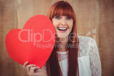 Smiling hipster woman with a big red heart