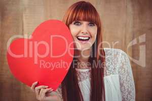 Smiling hipster woman with a big red heart
