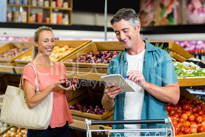 Smiling man looking at the grocery list