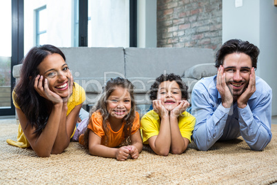 Smiling family on carpet in living room