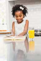 Smiling girl reading a book