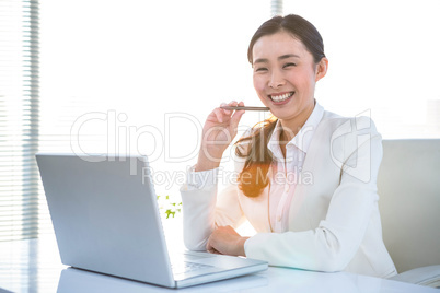 Smiling businesswoman holding a smartphone