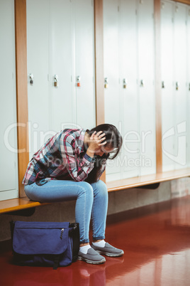 Worried student sitting with hands on head