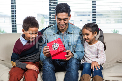 Happy father receiving a gift from his children