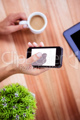 Overhead of feminine hand using smartphone