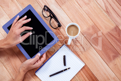 Overhead of feminine hands using tablet