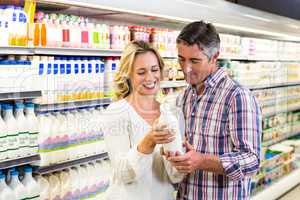 Smiling couple buying milk