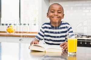 Smiling boy reading a book