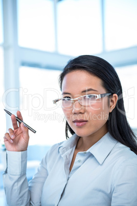 Attractive businesswoman holding pen