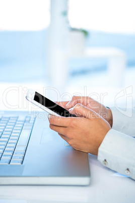 Cropped image of woman using smartphone