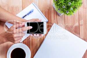 Overhead of feminine hands using smartphone