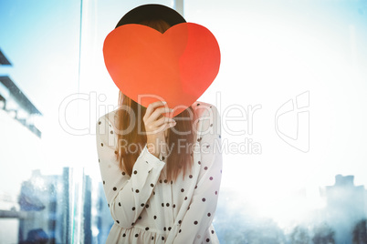 Attractive hipster woman behind a red heart