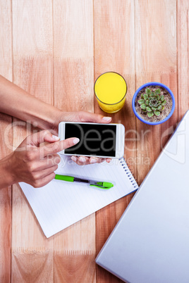 Overhead of feminine hands using smartphone