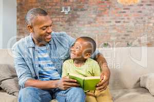 Father and son reading on the couch