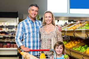 Smiling family behind their trolley