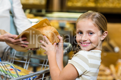 Daughter taking bread from paper bag