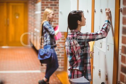 Pretty students opening lockers