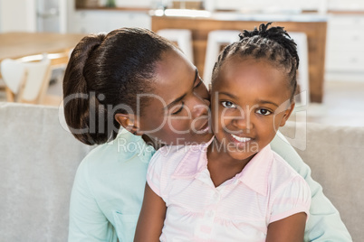 Loving mother with daughter on the couch