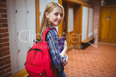 Pretty student with backpack looking at the camera