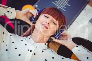 Attractive hipster woman with closed eyes and headphones