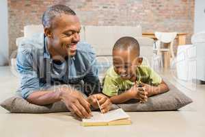 Father and son reading on the floor