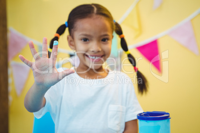 Girl smiling with paint on her finger