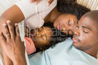 Pretty couple with daughter sleeping together