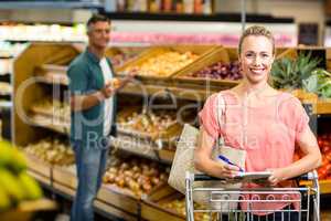 Smiling woman holding the grocery list