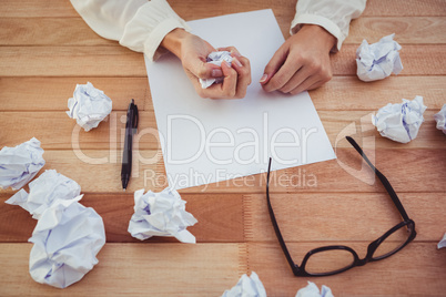 Cropped image of woman with crumpled paper