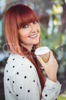Attractive smiling hipster woman with take-away cup
