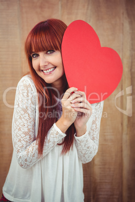 Smiling hipster woman with a big red heart