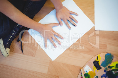 Boy painting with his hands