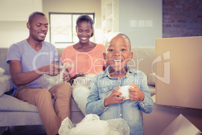 Family unwrapping things in new home