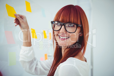 Attractive hipster woman holding  sticky notes