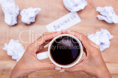 Businesswoman holding black coffee cup
