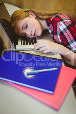 Blonde student sleeping on laptop